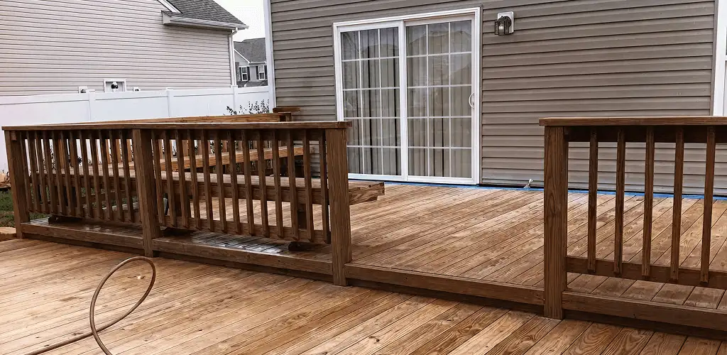 Deck sealing service protecting a backyard wood deck and railings in Des Moines, IA