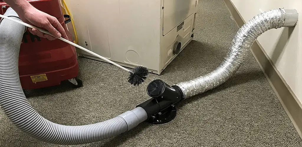 Dryer vent cleaning service removing lint from a dryer duct connection in Des Moines, IA