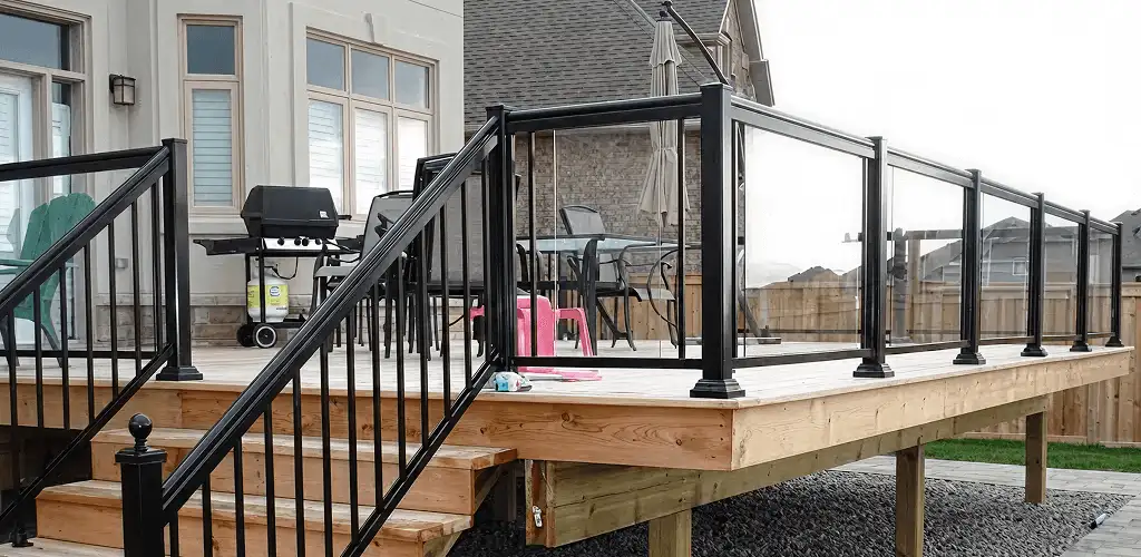 Handrail installation on a deck staircase for safety and code compliance in Des Moines, IA
