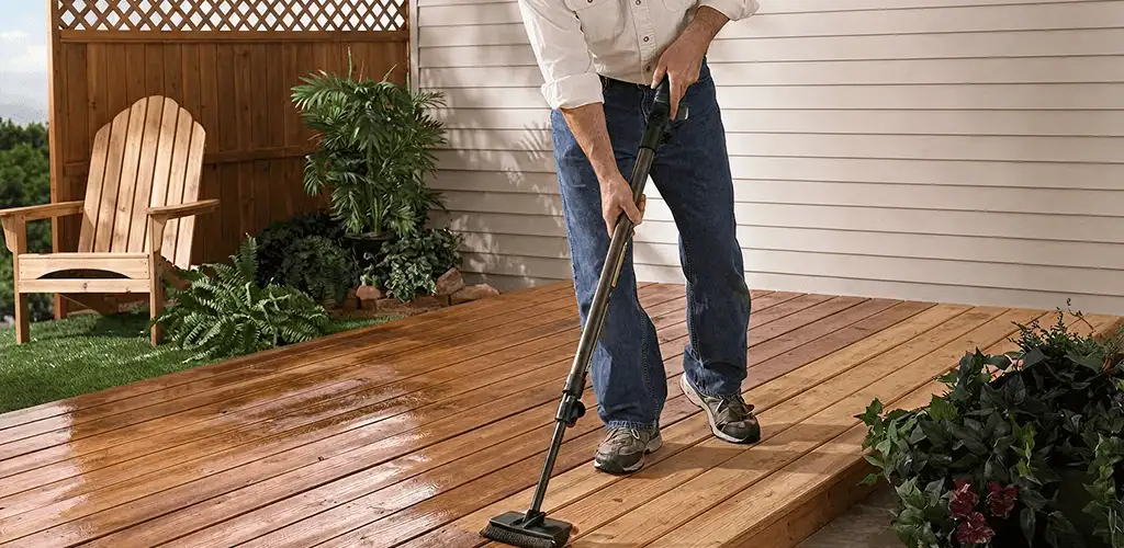 Deck staining service applying stain to a backyard wood deck in Des Moines, IA